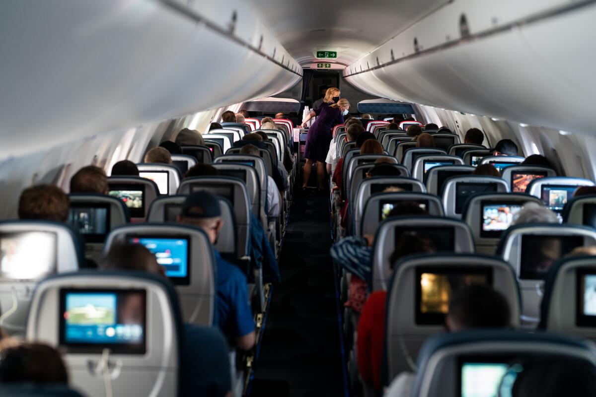 Flight attendants hand out refreshments on a Delta Airlines flight in May.