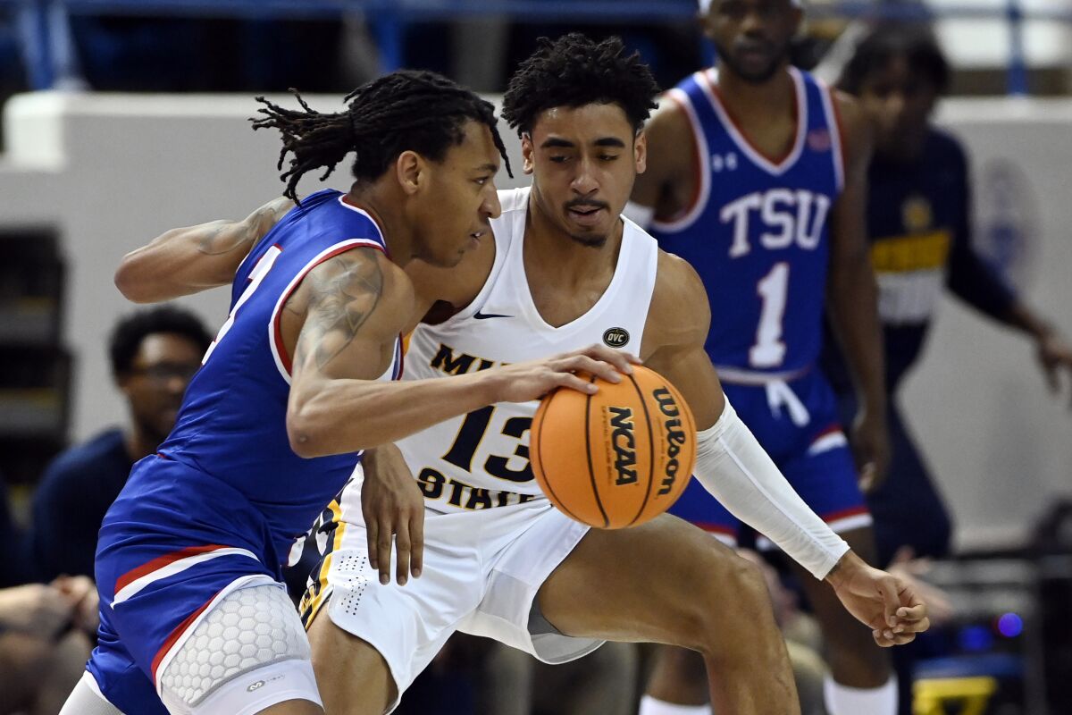 Tennessee State guard Tajik Bartholomew (3) is defended by Murray State guard Carter Collins (13) during the first half of an NCAA college basketball game Thursday, Feb. 10, 2022, in Nashville, Tenn. (AP Photo/Mark Zaleski)