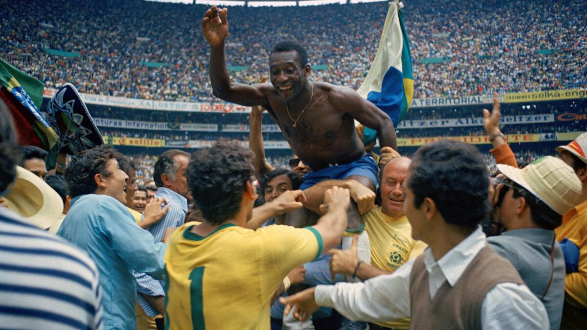  Pelé is lifted in celebration after Brazil's win over Italy in the 1970 World Cup final. 