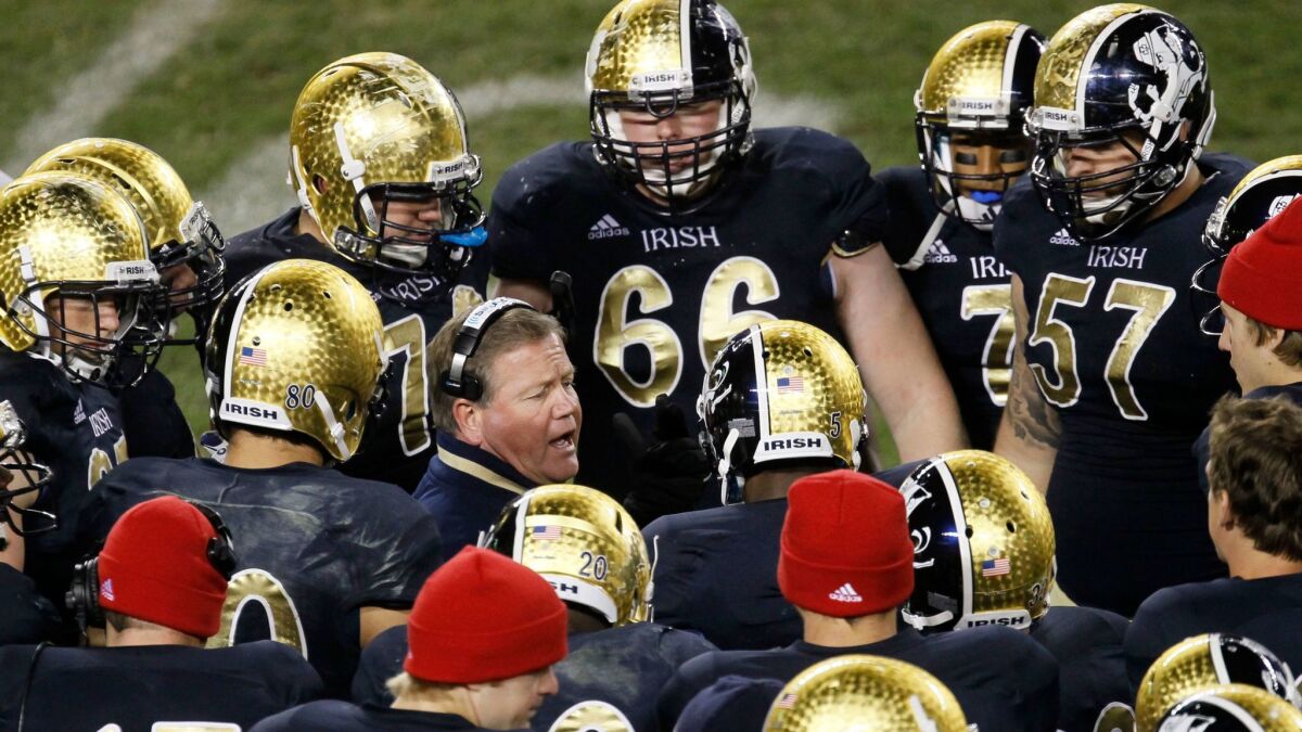 Notre Dame coach Brian Kelly talks to his players during a game against Miami in 2012. The NCAA upheld a decision that wipes away all 12 of the Irish's victories from that season.