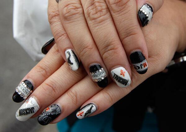 A fan shows off her painted nails as she waits in line for the 'Michael Forever. tribute concert.