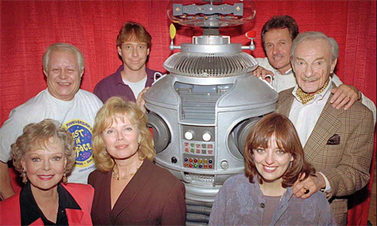 The crew from the original cast of the television series "Lost in Space" pose with the show's robot in in a 1995 file photo. From left in the back row are: Bob May, Bill Mumy, Mark Goddard, Jonathan Harris; in the front row from left: June Lockhart, Marta Kristen, Angela Cartwright.