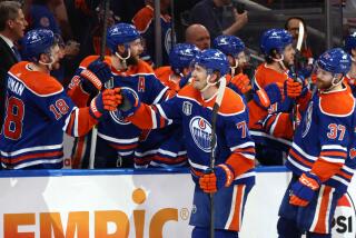 Edmonton forward Ryan McLeod, center, celebrates with teammates after scoring against Florida.