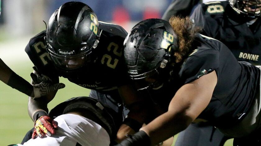 Narbonne football players make a tackle during the 2016 City Section Division I championship game against Dorsey.