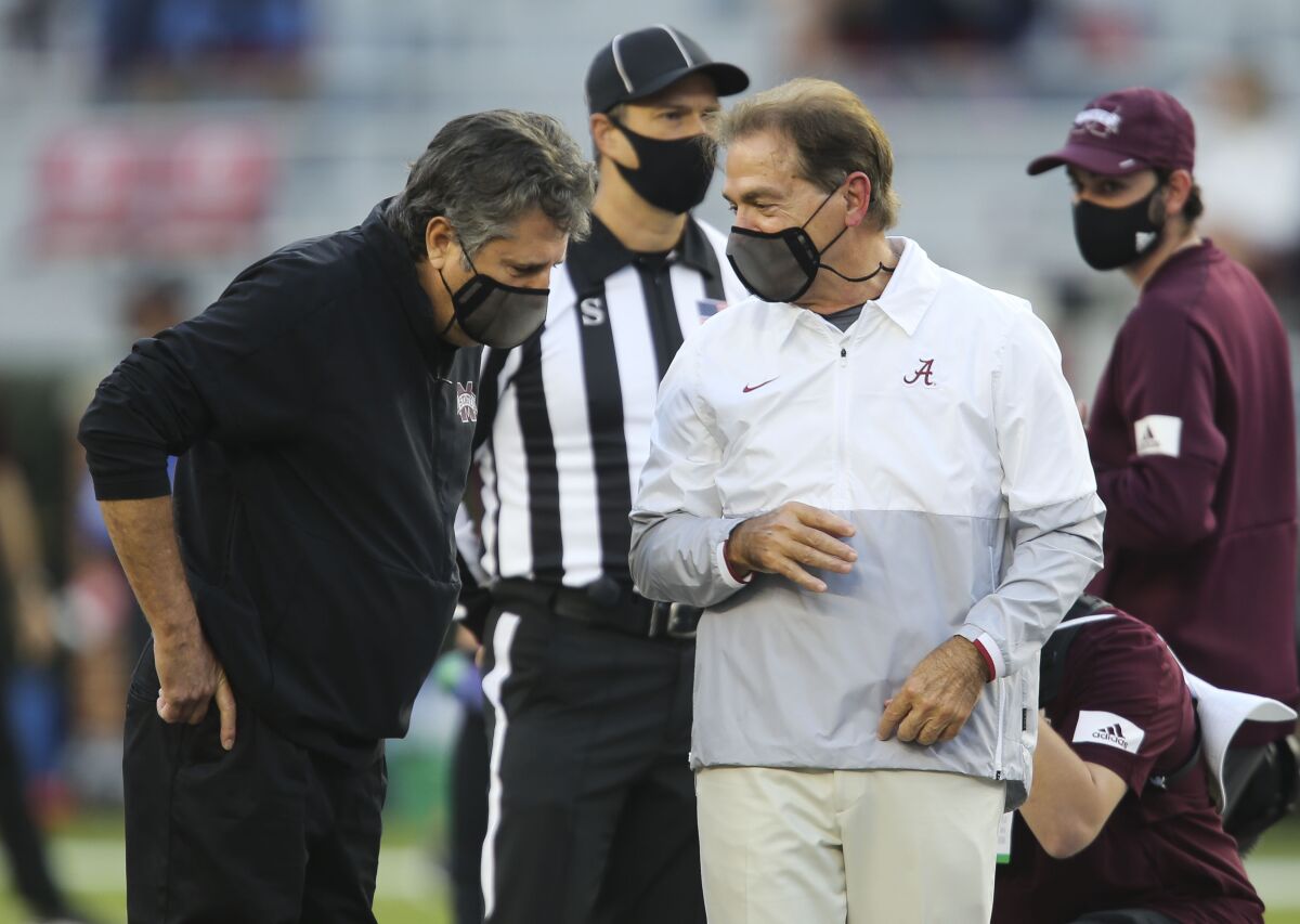 Mississippi State Head Coach Mike Leach, left, and Alabama Head Coach Nick Saban talk before the start of an NCAA college football game in Tuscaloosa, Ala., Saturday, Oct. 31, 2020. (Gary Cosby Jr/The Tuscaloosa News via AP)