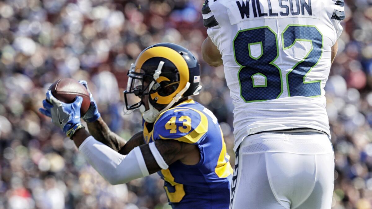 Rams safety John Johnson III steps in front of Seahawks tight end Luke Willson to intercept a pass from quarterback Russell Wilson.