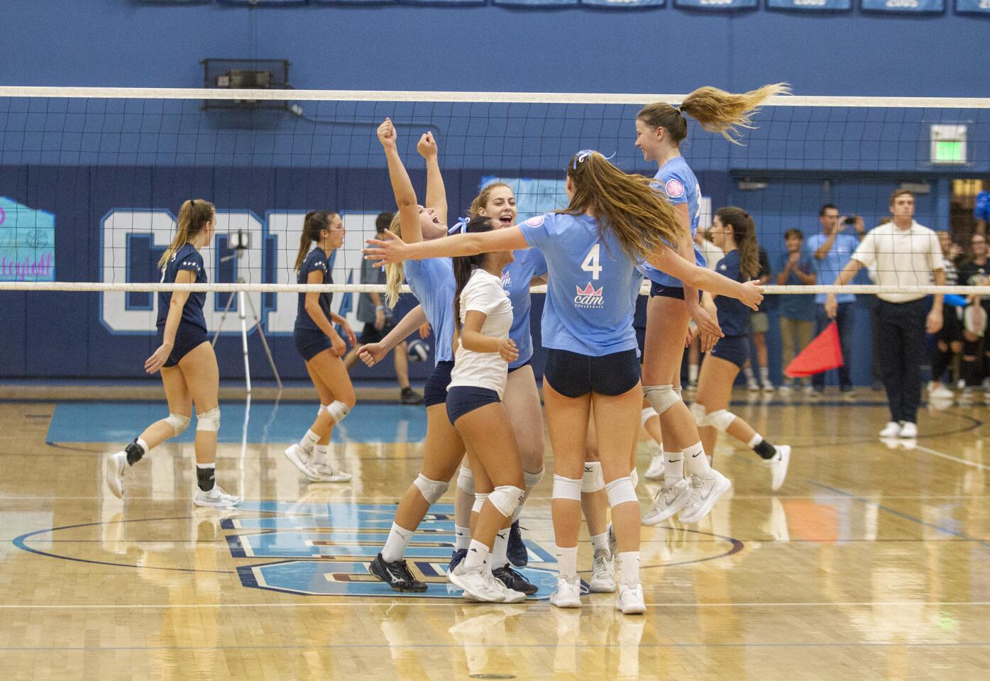 Corona del Mar celebrates after sweeping Newport Harbor 3-0 during the Battle of the Bay match on Thursday, October 11.