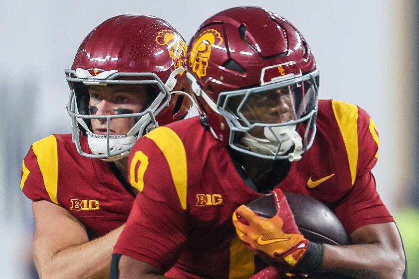 USC quarterback Miller Moss, left, hands off to running back Quinten Joyner against LSU.