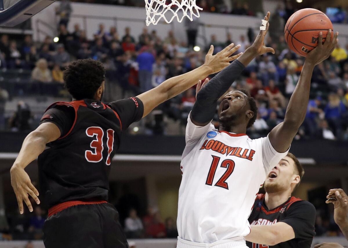 Louisville's Mangok Mathiang (12) heads to the basket against Jacksonville State's Christian Cunningham.