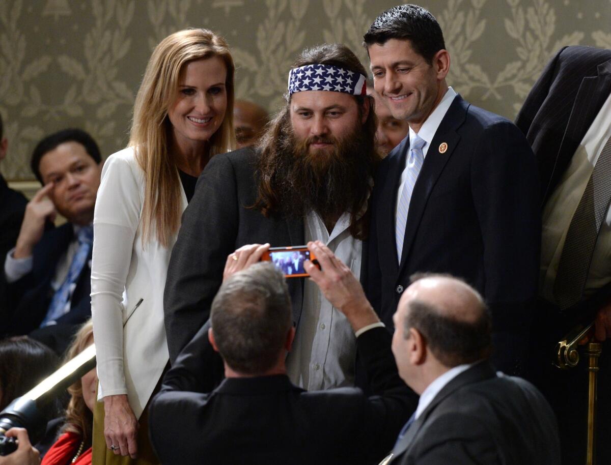 Korie and Willie Robertson of the television show "Duck Dynasty" pose for a picture with Rep. Paul D. Ryan (R-Wis.) before the State of the Union address.