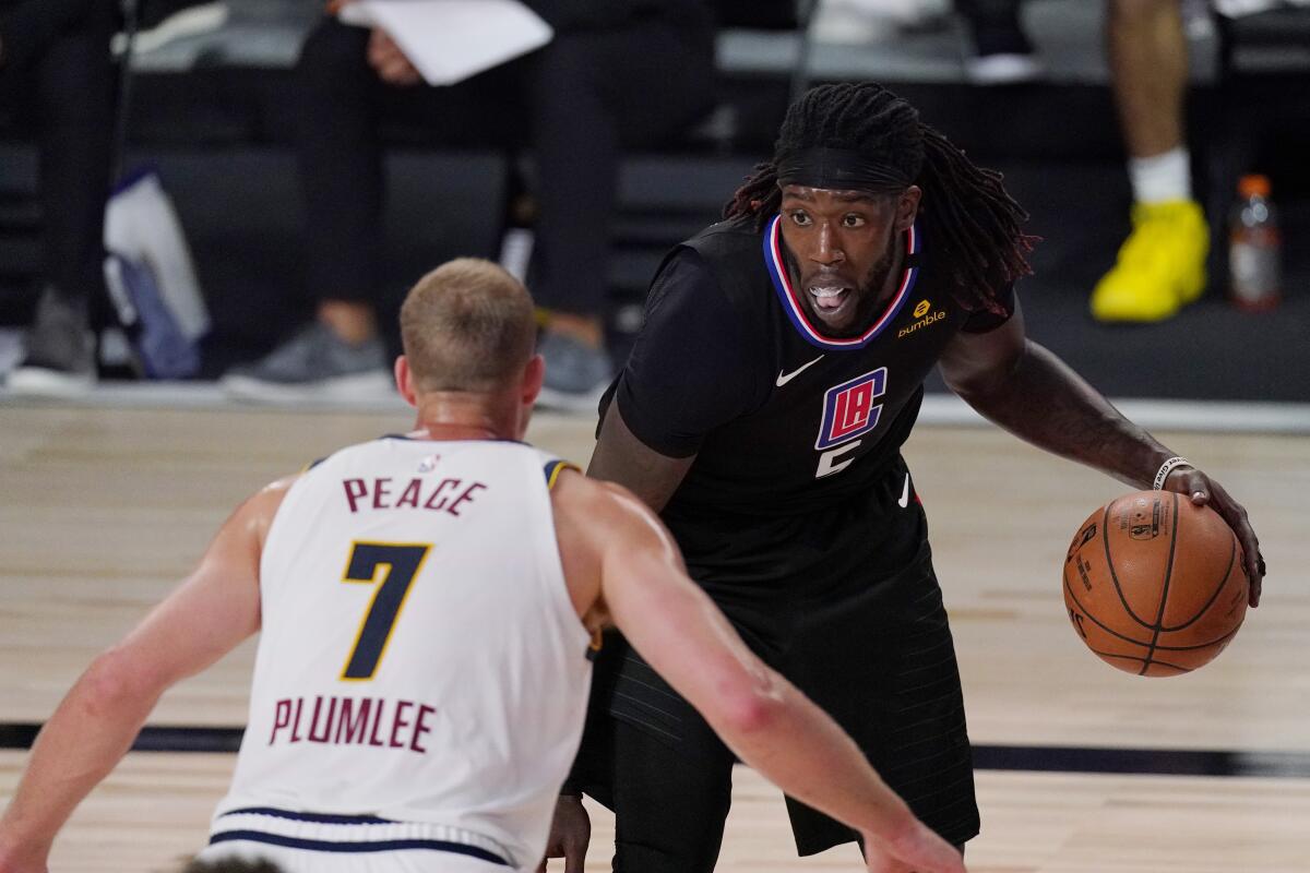 Clippers center Montrezl Harrell is defended by Nuggets center Mason Plumlee (7) during Game 1 on Sept 3, 2020.