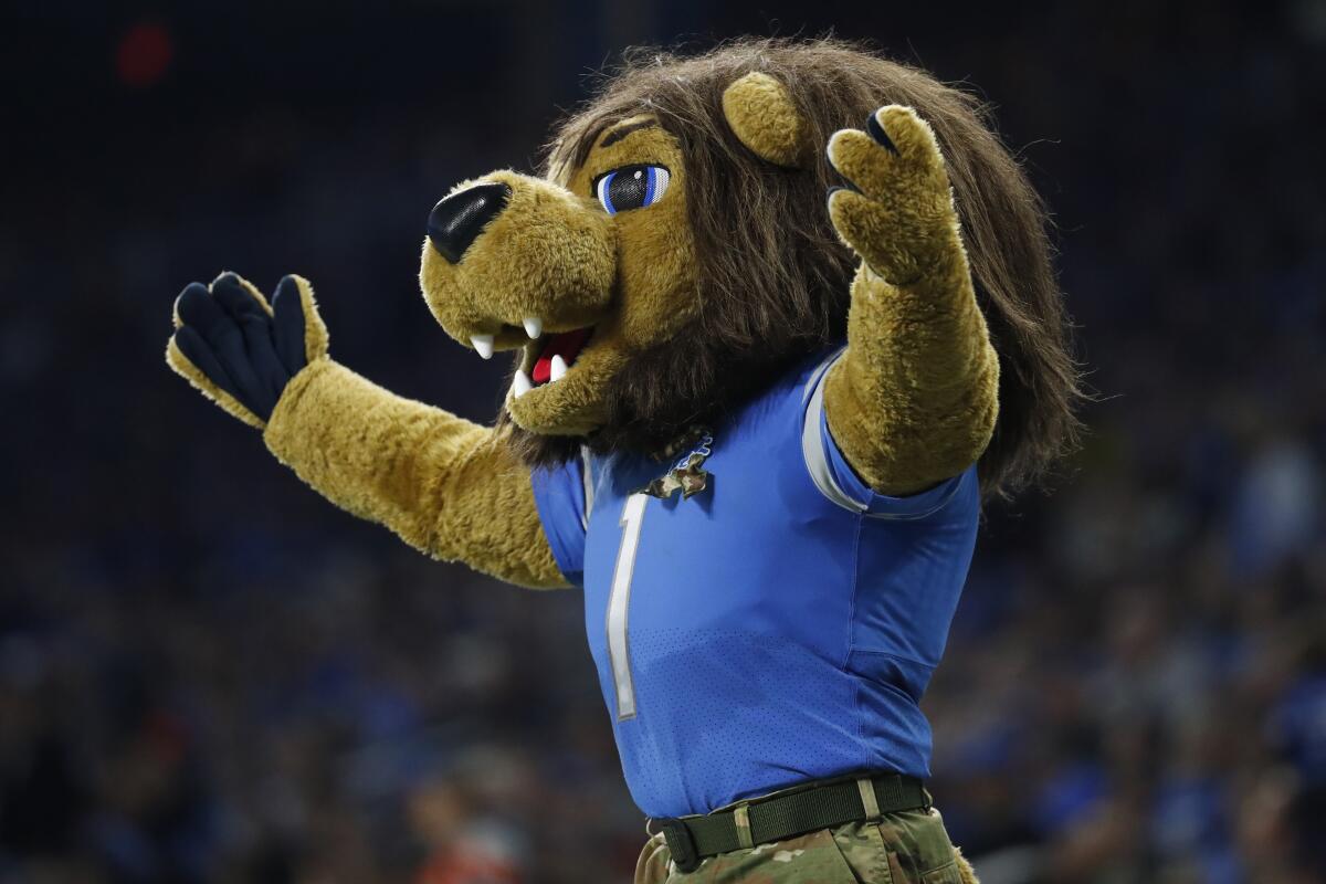 Roary, the Detroit Lions mascot rallies the crowd during the first half of an NFL football game