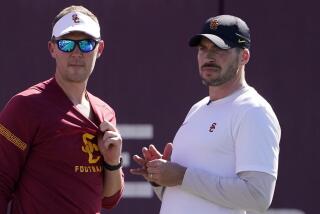 Southern California head coach Lincoln Riley, left, talks with defensive coordinator Alex Grinch.