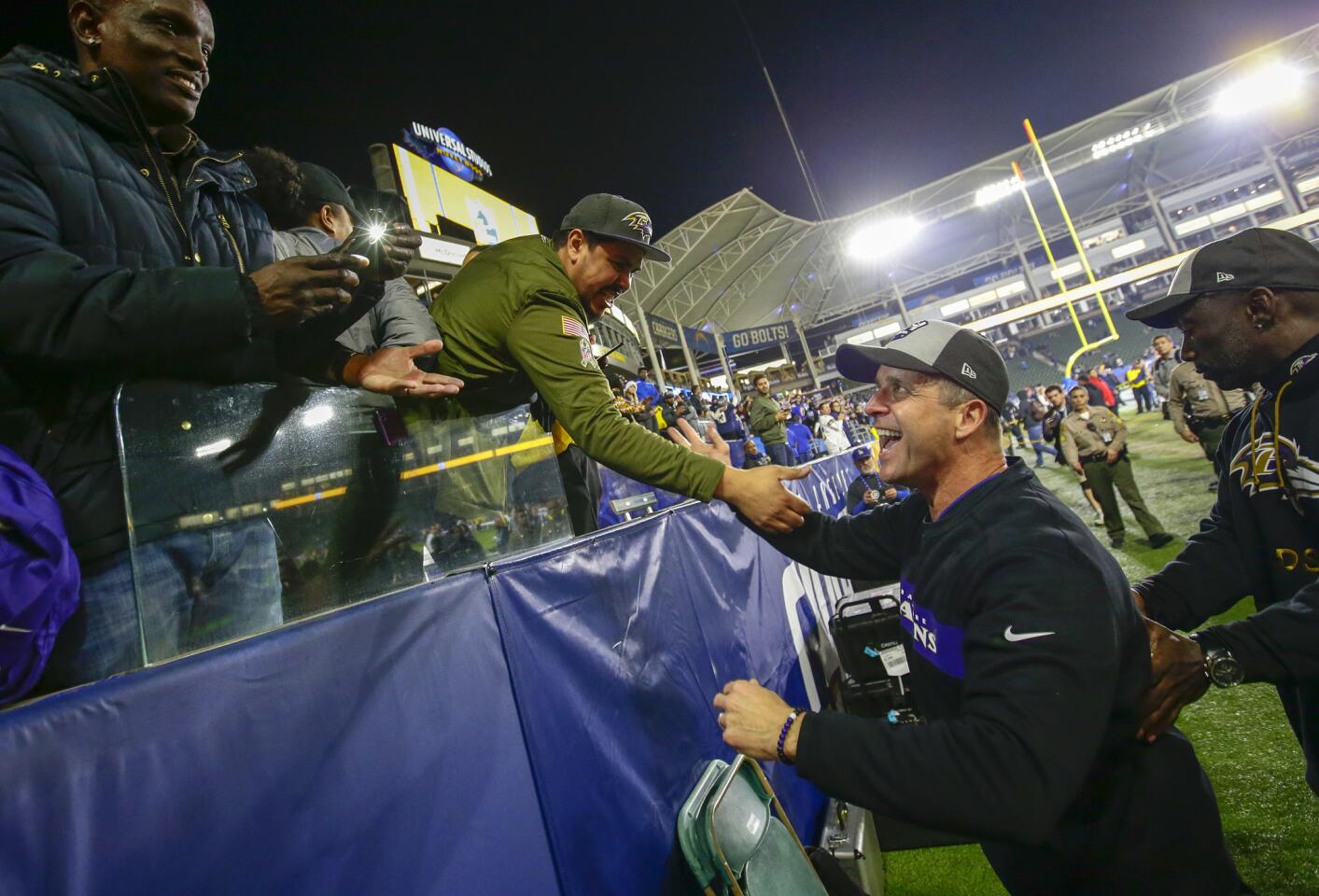 Ravens head coach John Harbaugh celebrates with fans after leading Baltimore to a 22-10 win over the Chargers at StubHub Center.