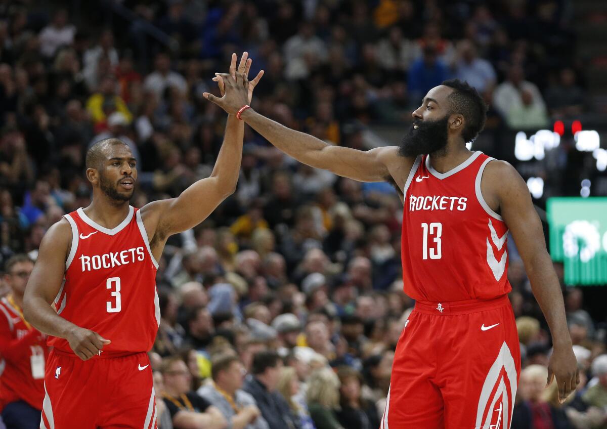 Houston Rockets' Chris Paul (3) and James Harden (13) celebrate in the second half during an NBA basketball game against the Utah Jazz Monday, Feb. 26, 2018, in Salt Lake City.