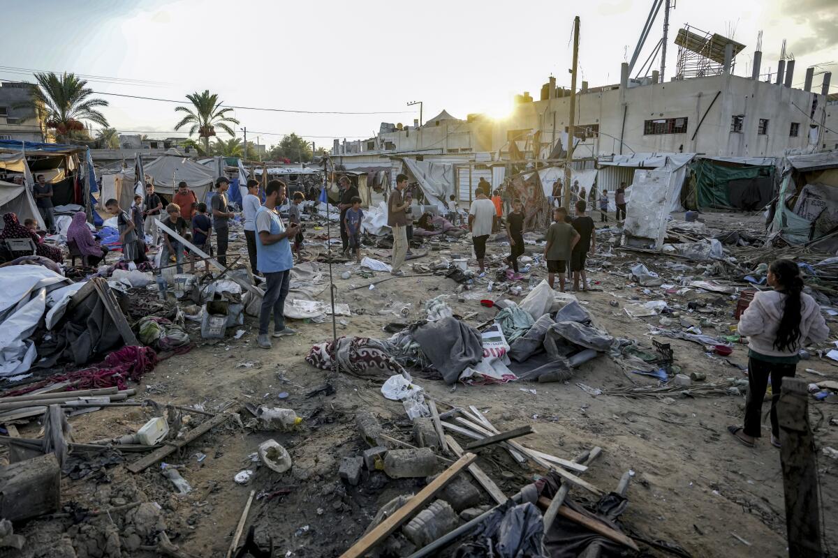 Palestinians inspect the damage at a tent area in the courtyard of Al Aqsa Martyrs Hospital.