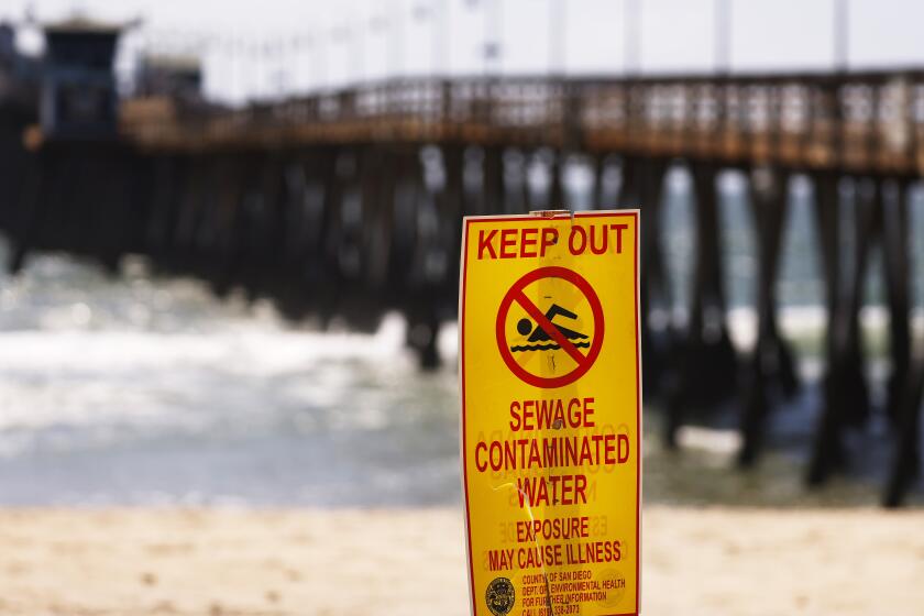 Imperial Beach, CA - April 24: Signs warn people of the contaminated ocean water in Imperial Beach on Wednesday, April 24, 2024. The water in the area has been contaminated for years from the Tijuana River sewage. (K.C. Alfred / The San Diego Union-Tribune)
