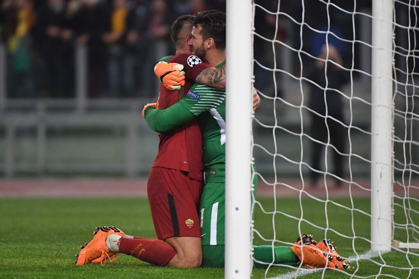 AS Roma's Serbian defender Aleksandar Kolarov (L) and AS Roma's Brazilian goalkeeper Alisson Becker celebrate their victory at the end of the UEFA Champions League quarter-final second leg football match between AS Roma and FC Barcelona at the Olympic Stadium in Rome on April 10, 2018.