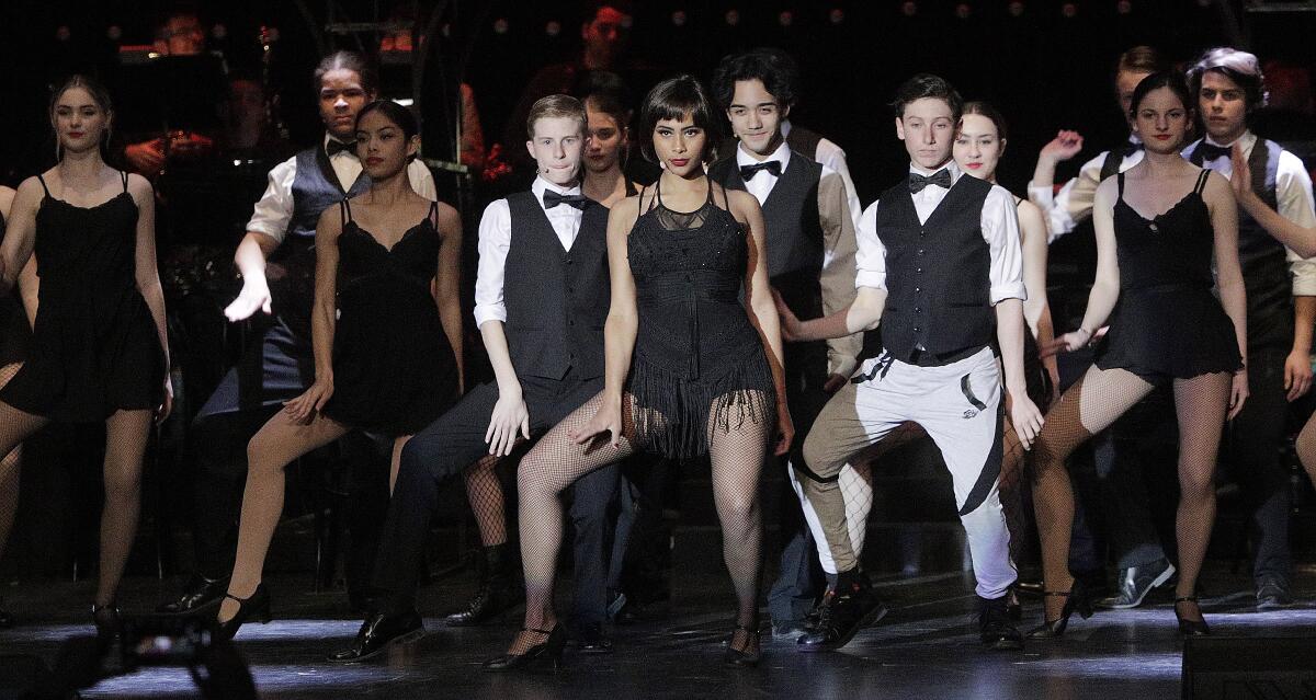 Velma Kelly, played by Janina Colucci, center, performs in the opening ensemble at a dress rehearsal of "Chicago" at Burroughs High School on Tuesday. The show will be performed in the school auditorium this weekend starting on Friday.