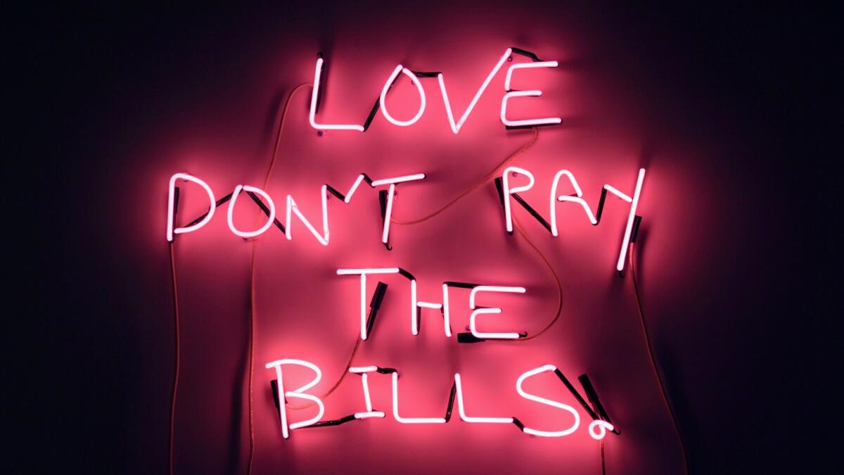 Eve de Haan’s pink neon “Love Don’t Pay the Bills" is part of the "She Bends" exhibit, featuring works by women neon artists.