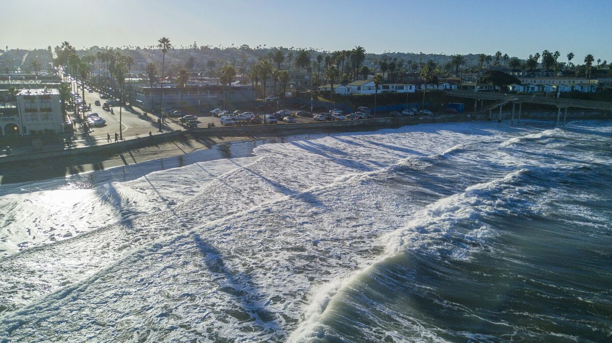 Waves rolled up to the sea wall in Ocean Beach, San Diego, on the first King Tide of the decade on Friday, January 10, 2020.