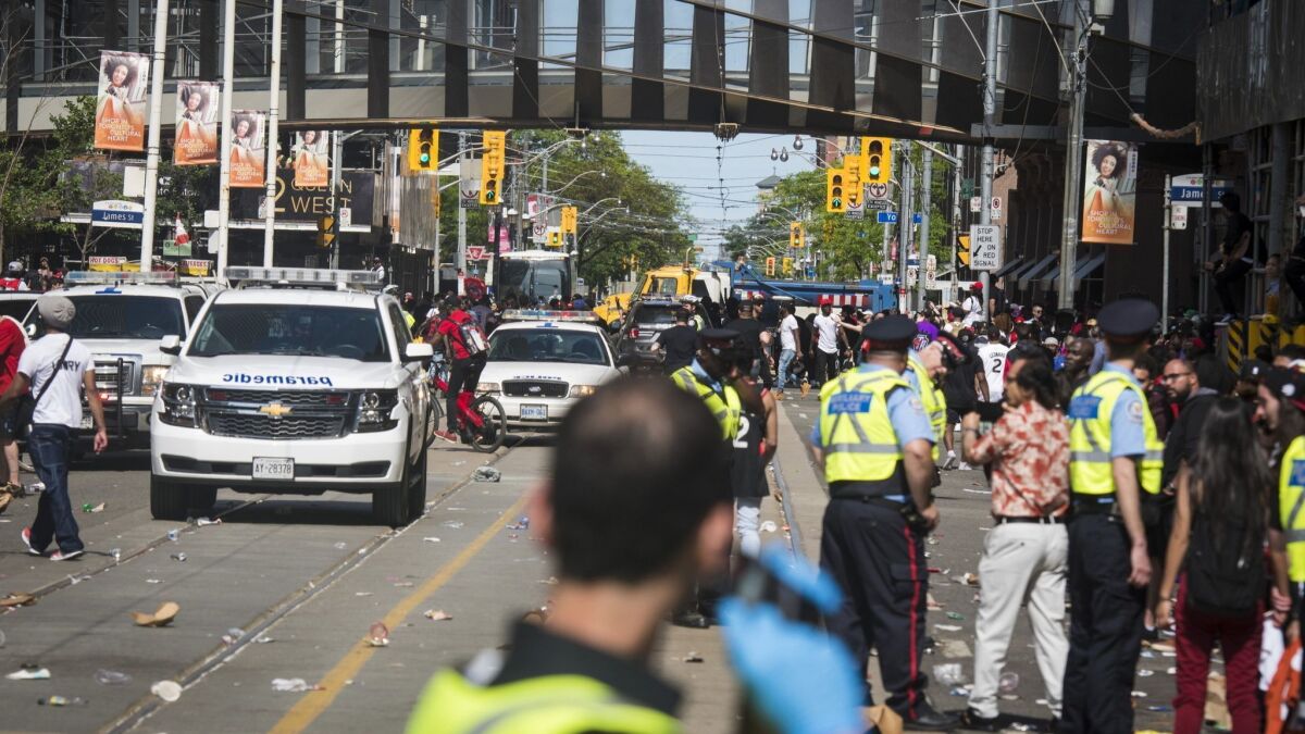 First responders make their way along Queen Street West after reports of shots fired during the Toronto Raptors NBA basketball championship victory celebration near Nathan Phillips Square in Toronto.