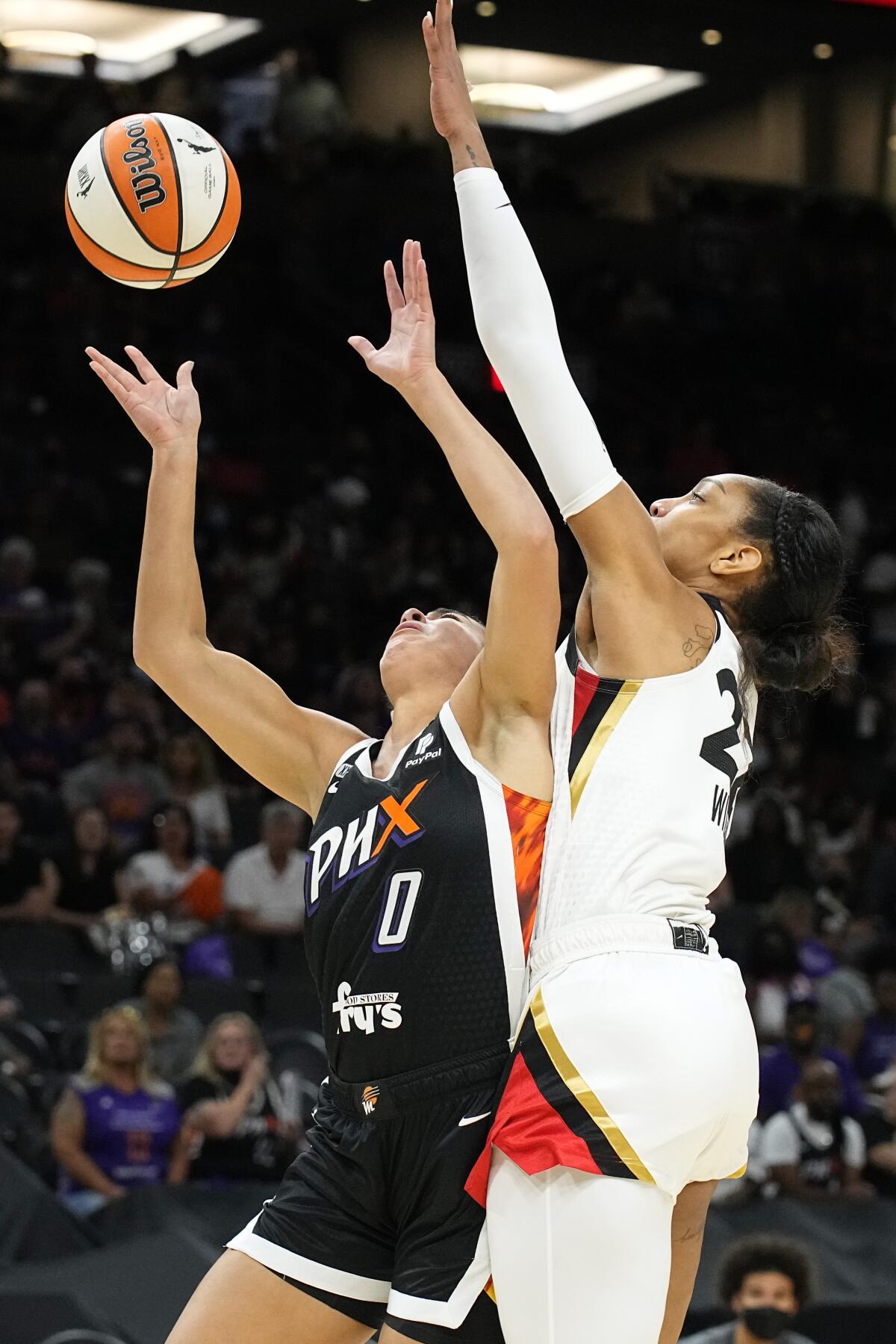 Las Vegas Aces forward A'ja Wilson (22) blocks a shot by Phoenix Mercury guard Kia Nurse during the first half of Game 4 of a WNBA basketball playoff series Wednesday, Oct. 6, 2021, in Phoenix. Nurse was hurt on the play and did not play again in the first half. (AP Photo/Rick Scuteri)