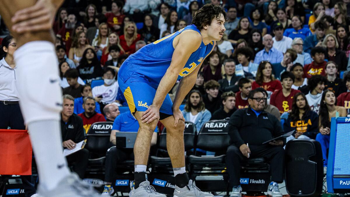 UCLA star Ethan Champlin stands on the court during a match against USC
