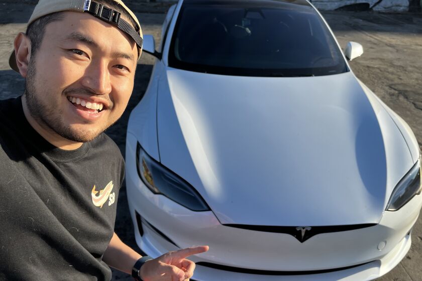 Dennis Wang with his current Tesla, a Model Y. 
