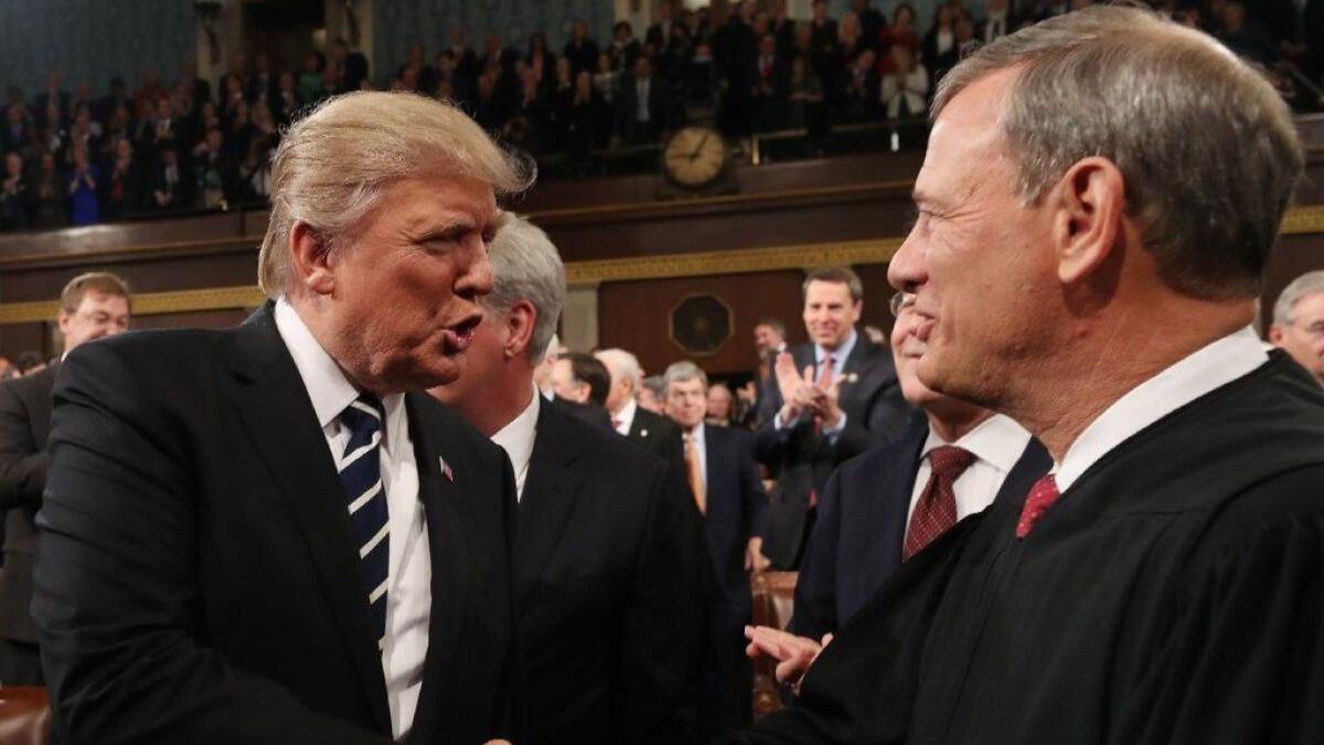 President Trump shakes hands with Chief Justice John G. Roberts Jr. before delivering his first address to a joint session of Congress on Feb. 28, 2017.