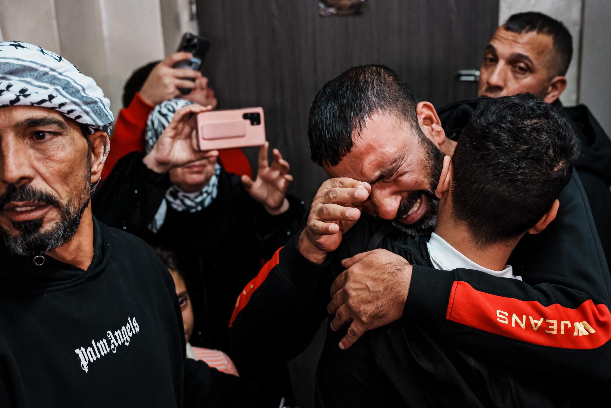 Family members embrace Ahmad Salaymah after his release from prison, 