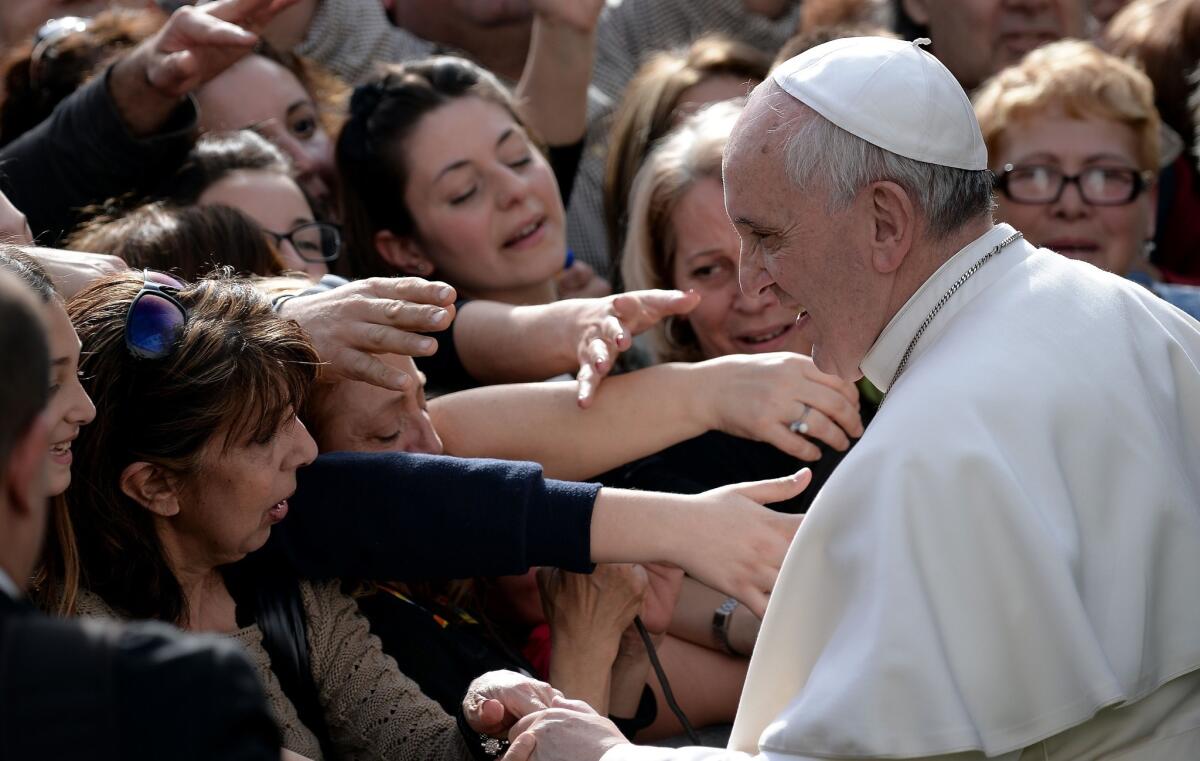 Pope Francis meets with congregants as he visits San Gregorio Parish in Rome on Sunday.