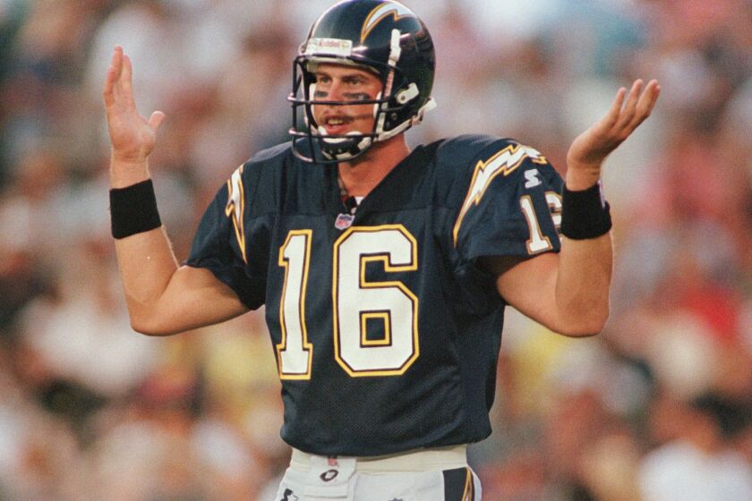 FILE - In this Aug. 8, 1998, file photo, San Diego Chargers rookie quarterback Ryan Leaf, the No. 2 selection in the NFL draft, tries to figure out what play is being called from the bench during the first quarter against the San Francisco 49ers in an NFL football game in San Diego. Leaf labels himself as “the biggest bust in draft history”. The second pick in the 1998 draft after a stellar career at Washington State, Leaf played in only 21 games with the Chargers over three seasons and threw 33 interceptions with only 13 touchdowns while going 4-14 as a starter. (AP Photo/Kent Horner, File)