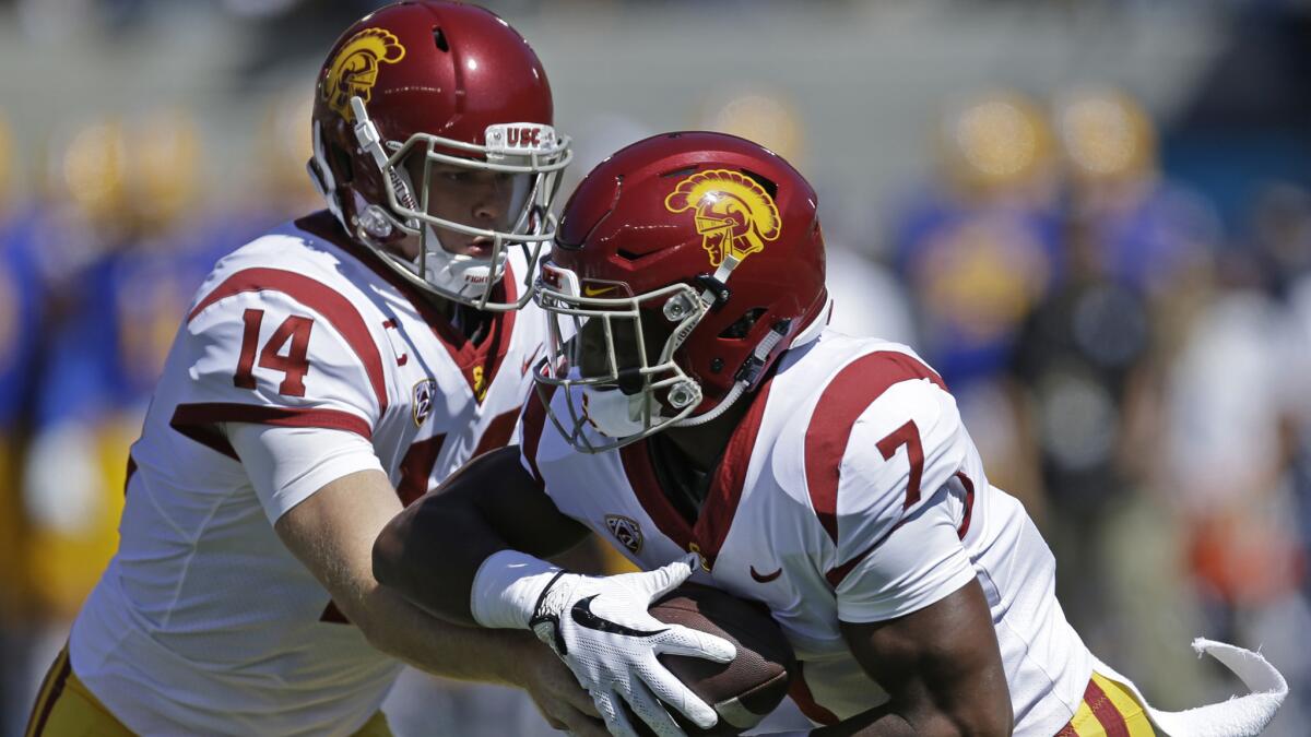 USC's quarterback Sam Darnold hands off to Stephen Carr during the first half of Saturday's game against Cal.