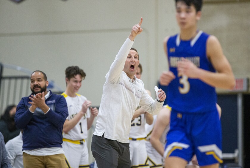 Marina's Nick Racklin yells instructions to his team during a Wave League boys' basketball game against Fountain Valley.