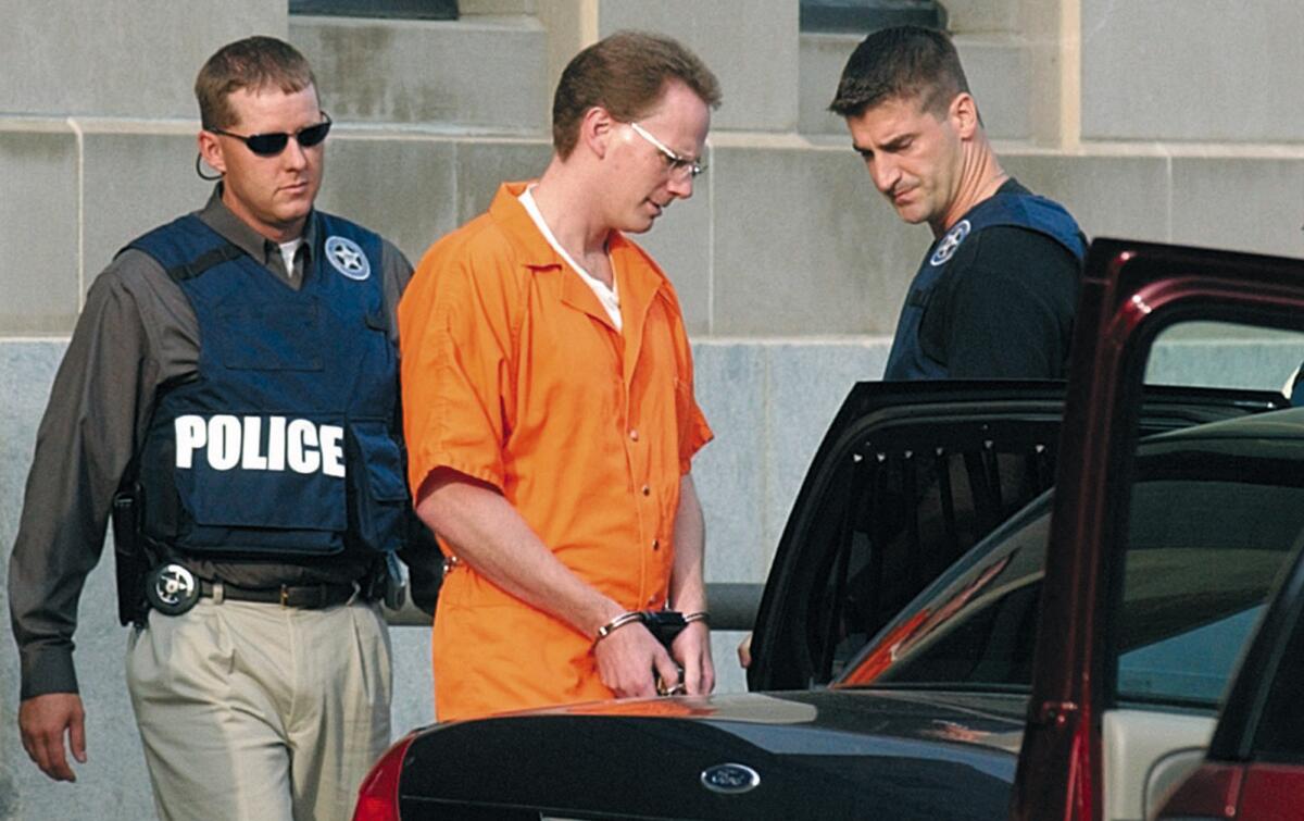 Dustin Honken is led by federal marshals to a waiting car in Sioux City, Iowa, in 2004.