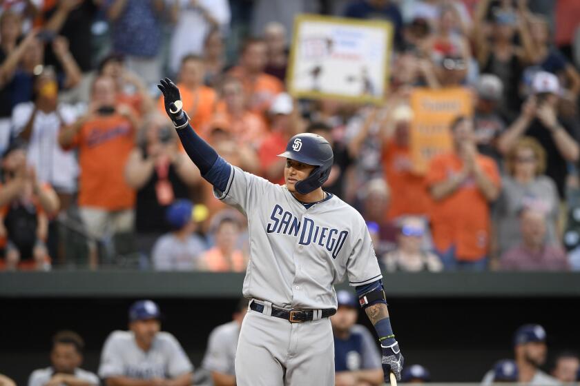 San Diego Padres' Manny Machado acknowledges the crowd during the first inning of a baseball game against his former team, the Baltimore Orioles, Tuesday, June 25, 2019, in Baltimore. (AP Photo/Nick Wass)
