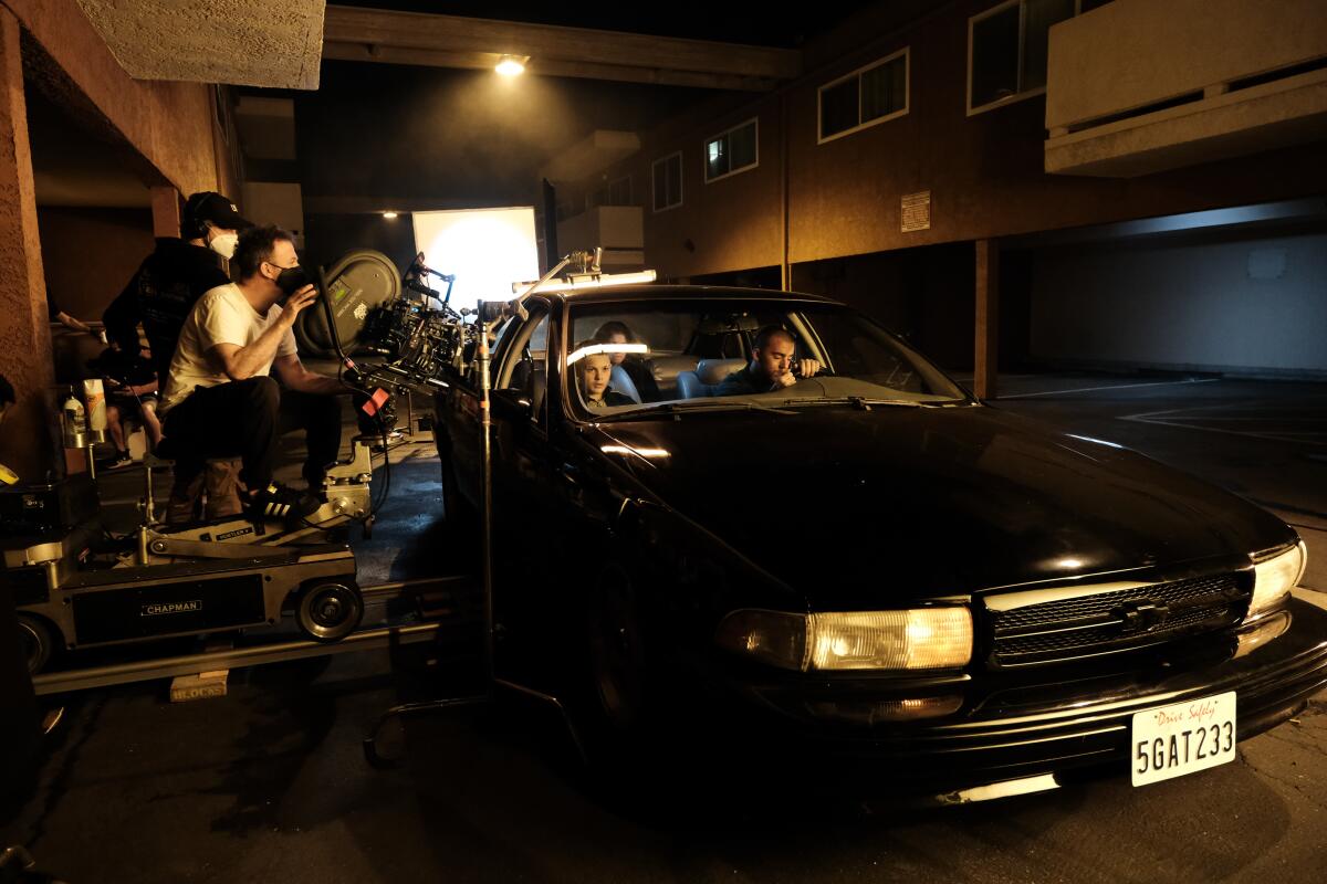A cameraman shoots a scene of teens in a car on the set of "Euphoria."