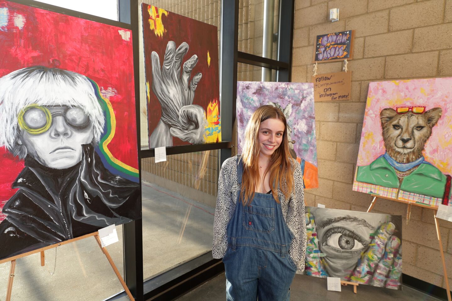 Camryn Jacobs with several of her art projects