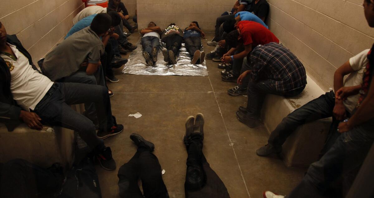 Immigrants wait at the U.S. Border Patrol station in McAllen, Texas, for processing.