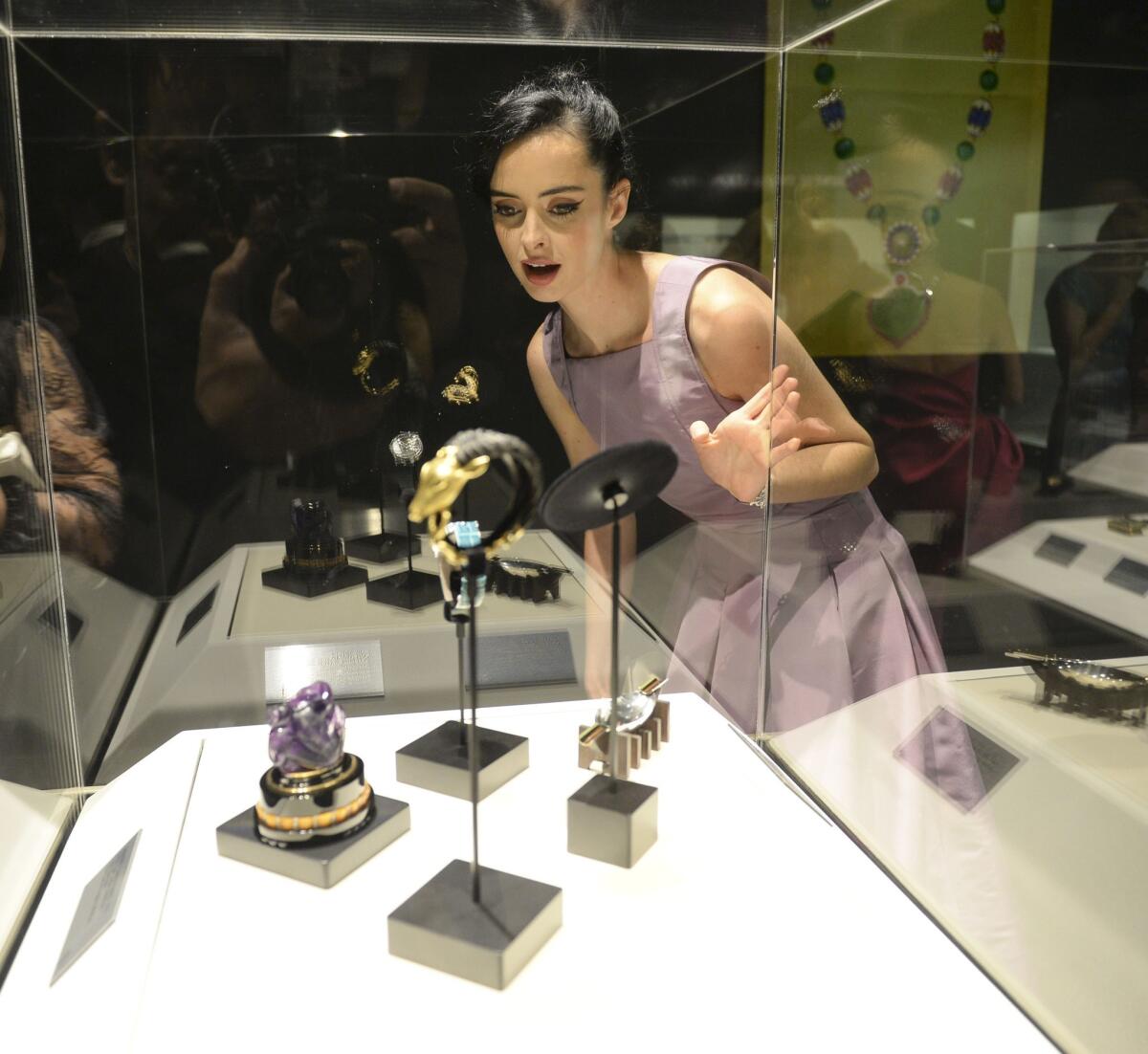 Krysten Ritter views some of the pieces on display at "A Quest for Beauty: The Art Of Van Cleef & Arpels" at the Bowers Museum in Santa Ana