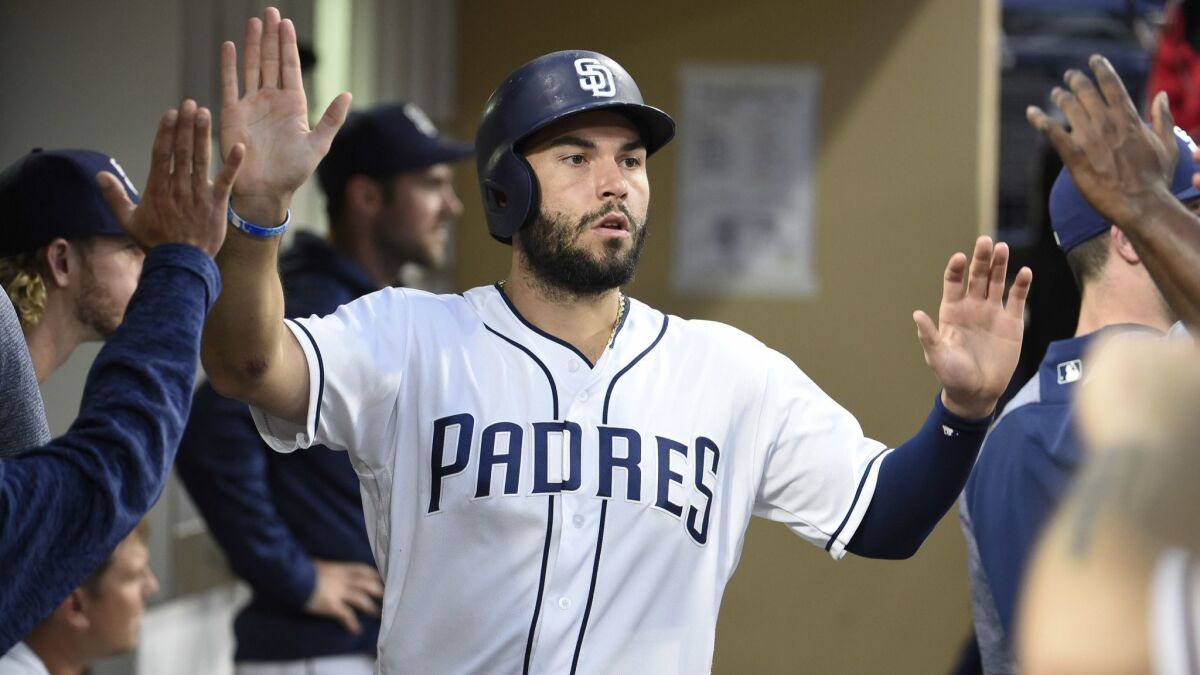 The Padres' Eric Hosmer is congratulated after scoring during the fifth inning of a baseball game against the Miami Marlins at Petco Park on May 31, 2018 in San Diego, California.
