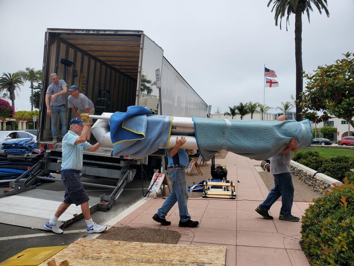 Volunteers help unload the pipes of St. James by-the-Sea Episcopal Church's new organ.