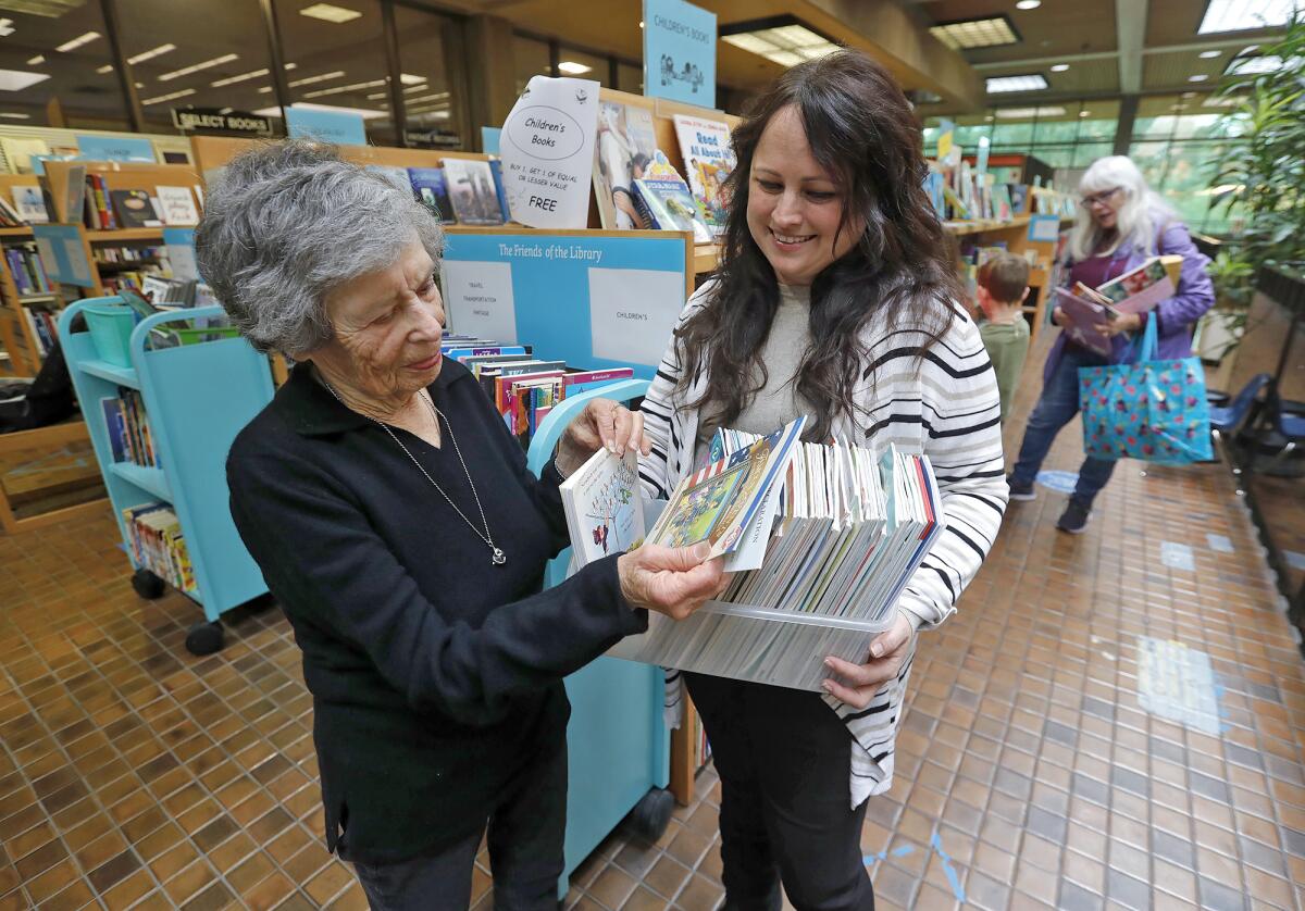 Sheila Plotkin, left, and Amber Cambria in the Friends of the Library store at Huntington Beach Central Library.