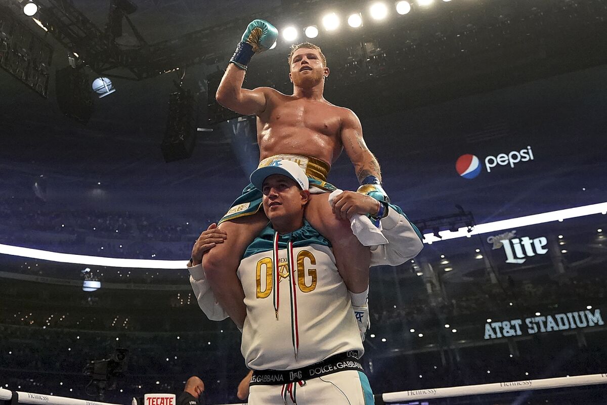 Canelo Alvarez celebrates after defeating Billy Joe Saunders in a unified super middleweight world championship boxing match, Saturday, May 8, 2021, in Arlington, Texas. (AP Photo/Jeffrey McWhorter)