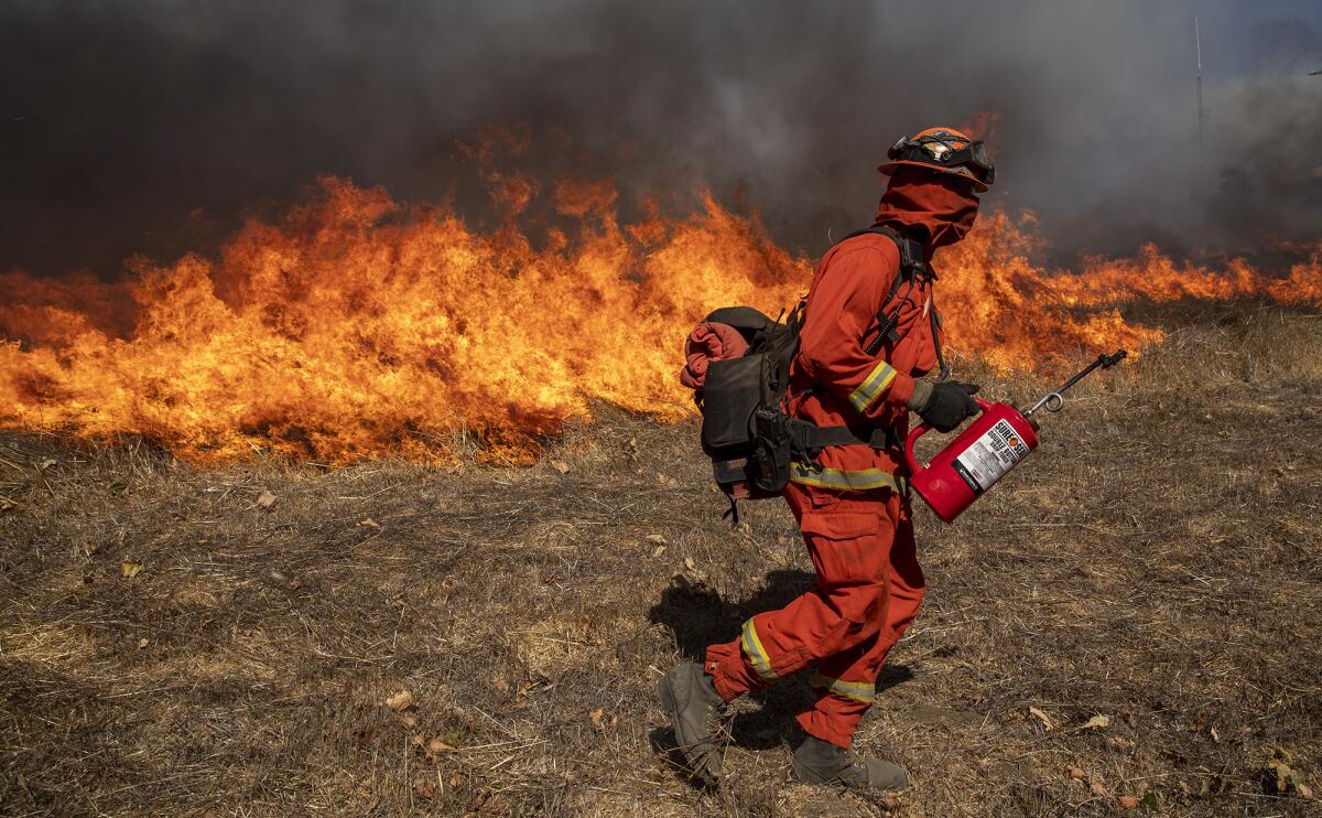 Inmate crews set fires in thick brush near Thousand Oaks.