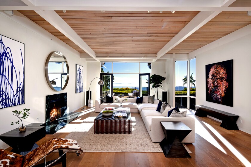 room with fireplace and furniture and ocean view
