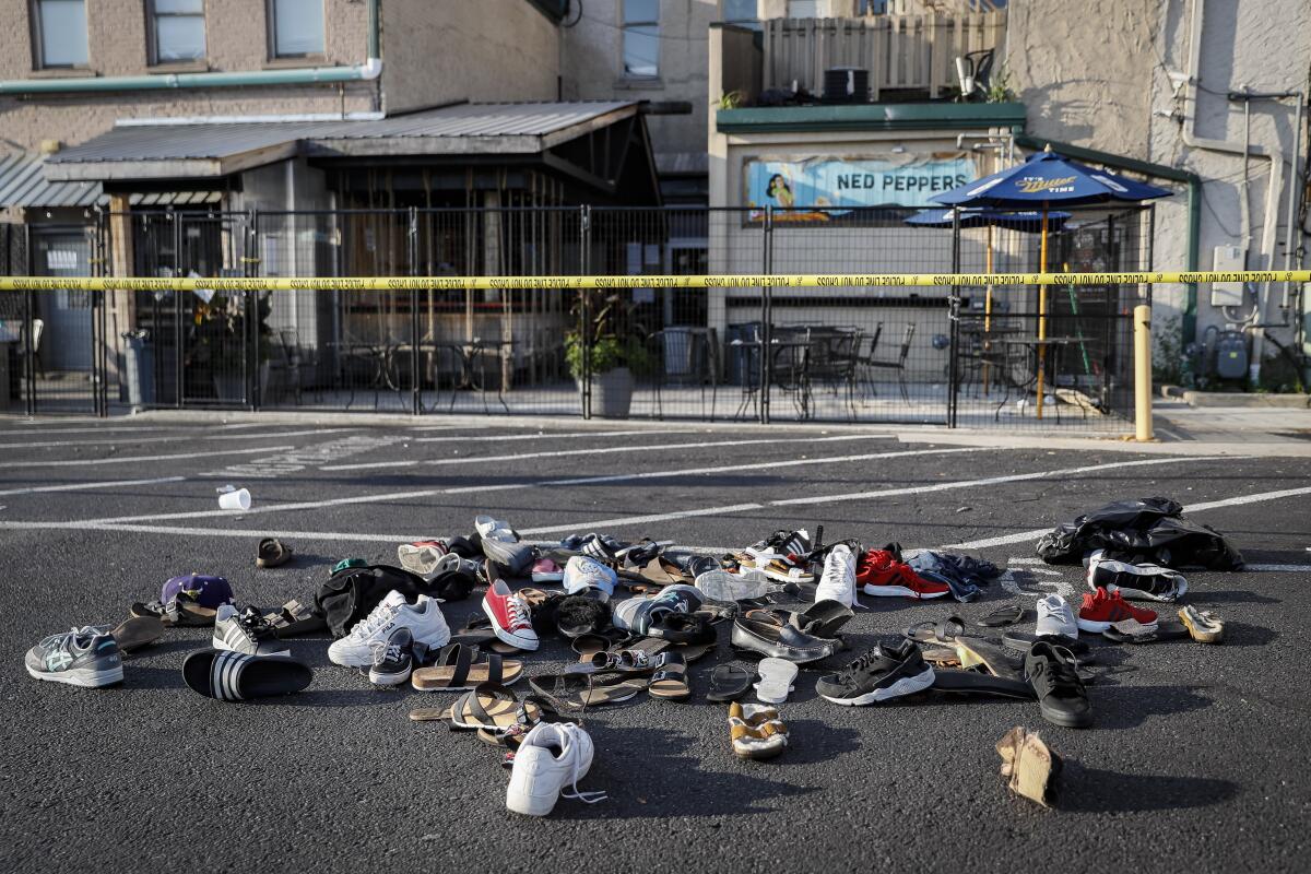 Shoes are piled outside the scene of a mass shooting in Dayton, Ohio. 