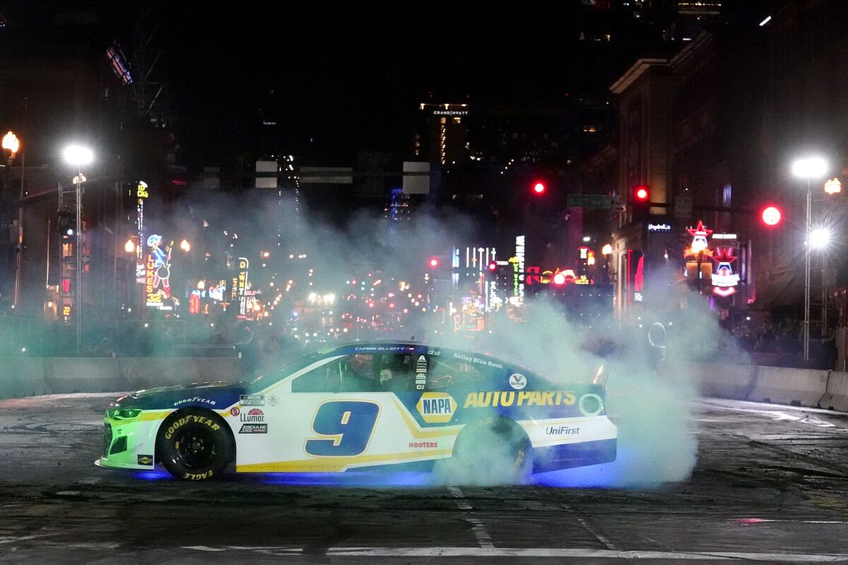 Chase Elliott does a burnout during the Burnouts on Broadway competition as part of NASCAR Champion's Week, Wednesday, Dec. 1, 2021, in Nashville, Tenn. (AP Photo/Mark Humphrey)
