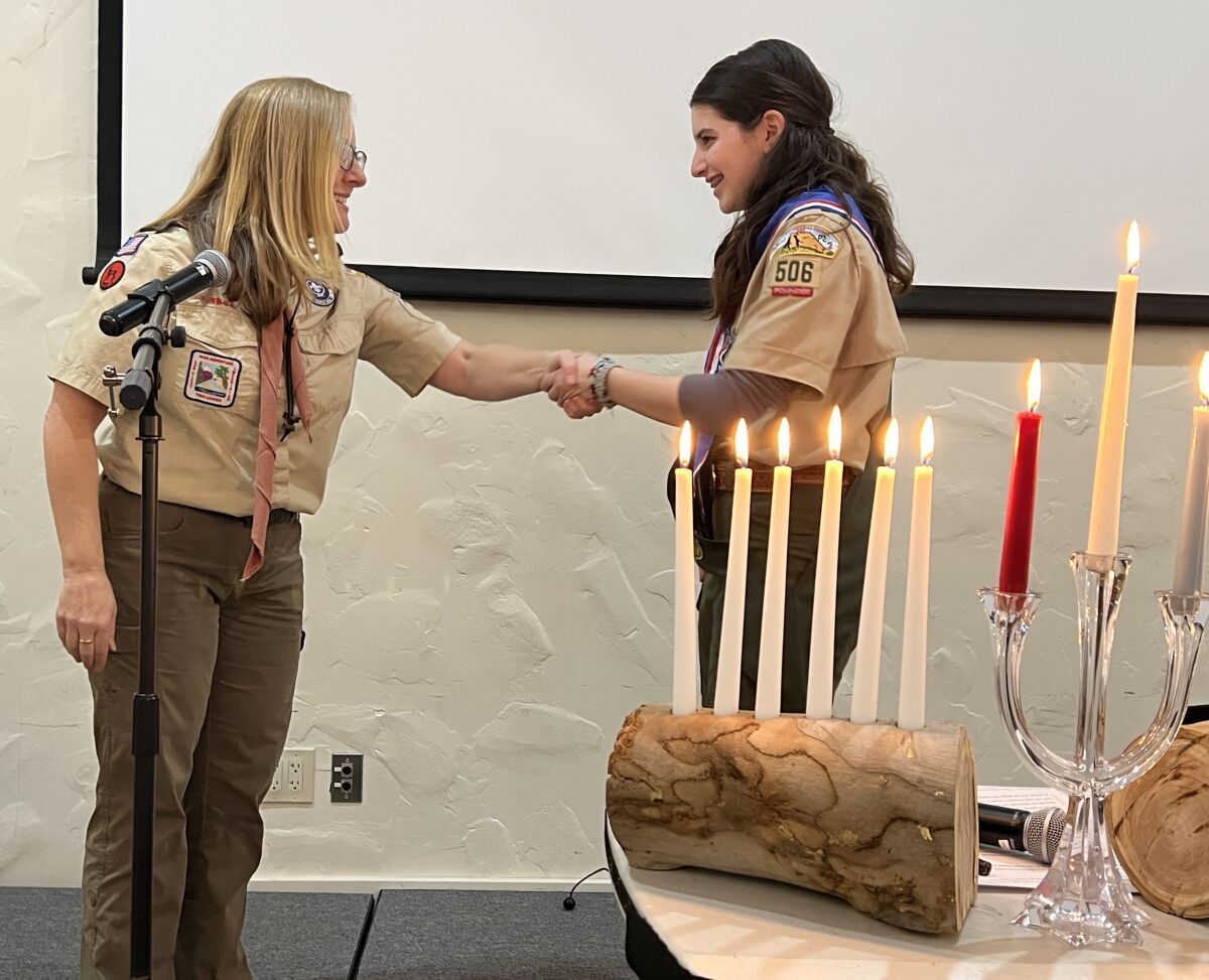 Troop 506G Scoutmaster Marnie Stransky congratulates CeCe Campbell on her Eagle Scout accomplishment.